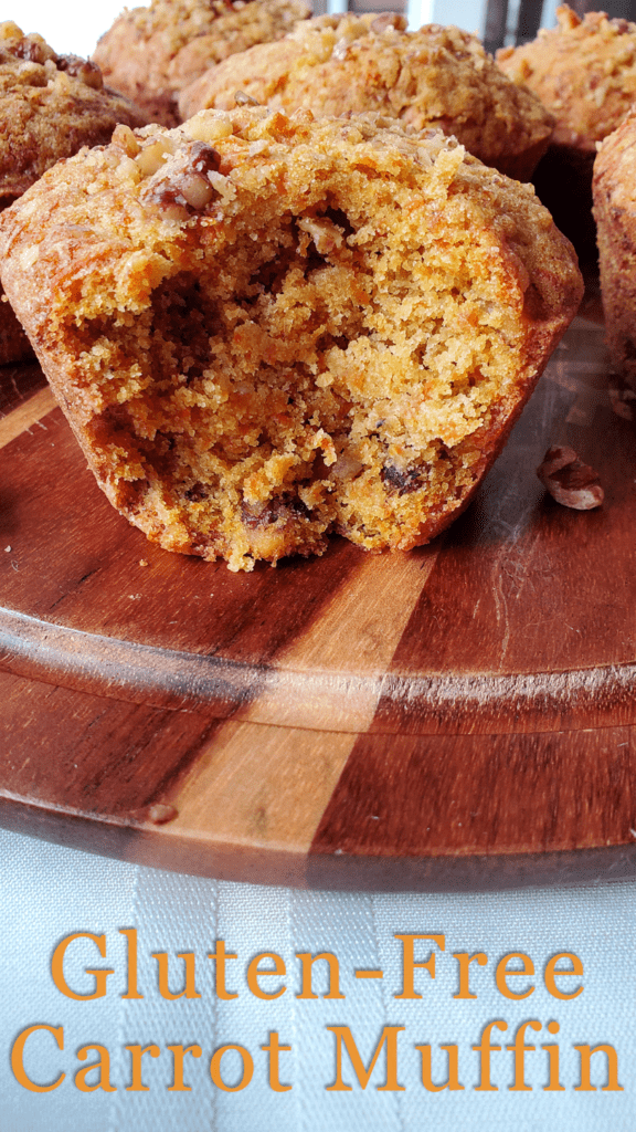 This is an image of the gluten-free healthy carrot cake muffins that shows the flaky texture, bright orange colors from the carrots, and sprinkled walnuts. 