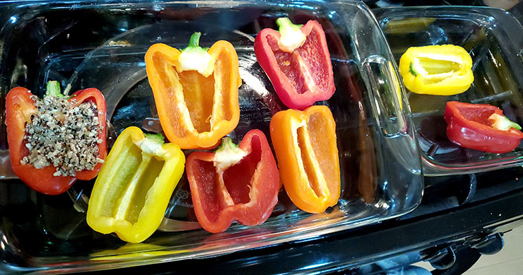 Pre-stuffed bell peppers sliced in half vertically.