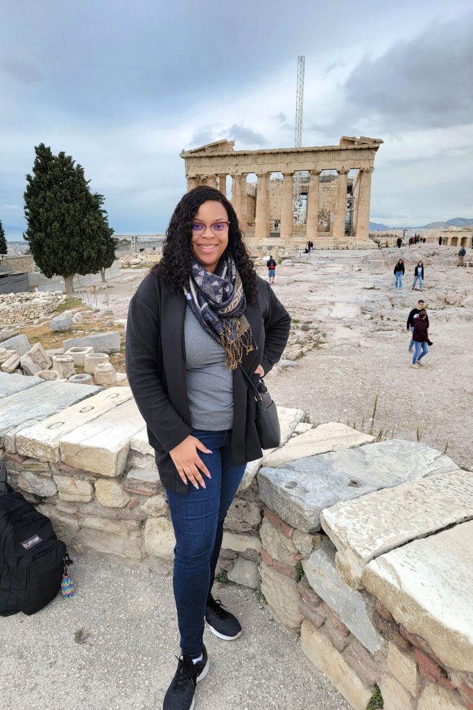 This is an image of T at Acropolis with the Parthenon in the background while traveling in Greece. 
