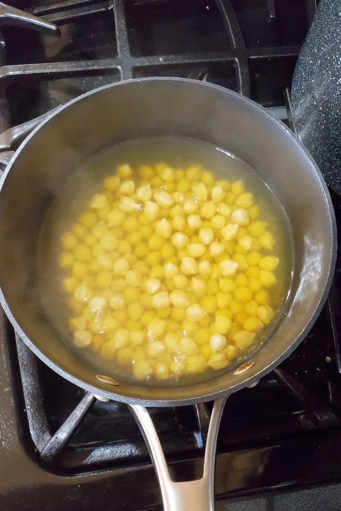 This is an image of boiling chickpeas for the chickpea quinoa burgers.