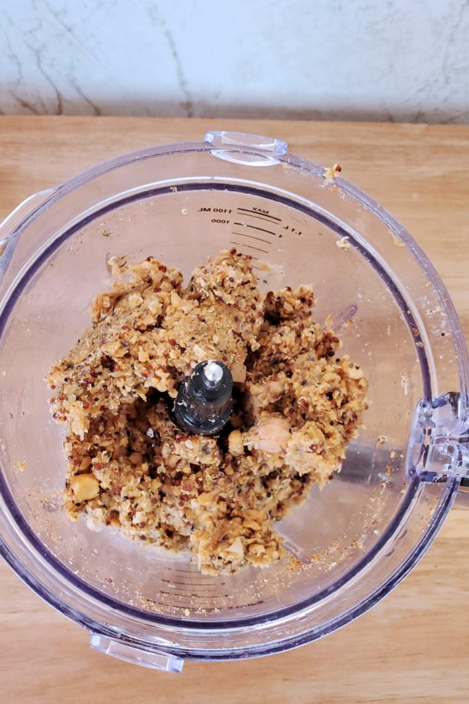 This is an image of the chickpea quinoa burgers in a food processor along with the spice mixture. 