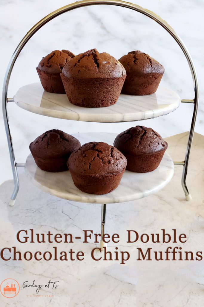 This is an image of the gluten-free double chocolate chip muffins on marble tiers.