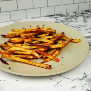 This is an image of the baked French Fries, garnished with fresh parsley.