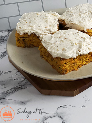 This is an image of 3 gluten-free carrot cake squares with nut icing.