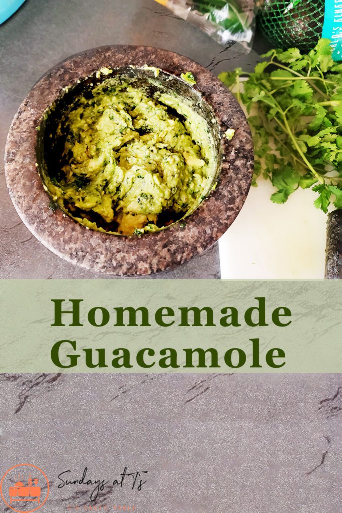 This is an image of the best guacamole recipe, staged with cilantro, avocado, and jalapeno peppers. 