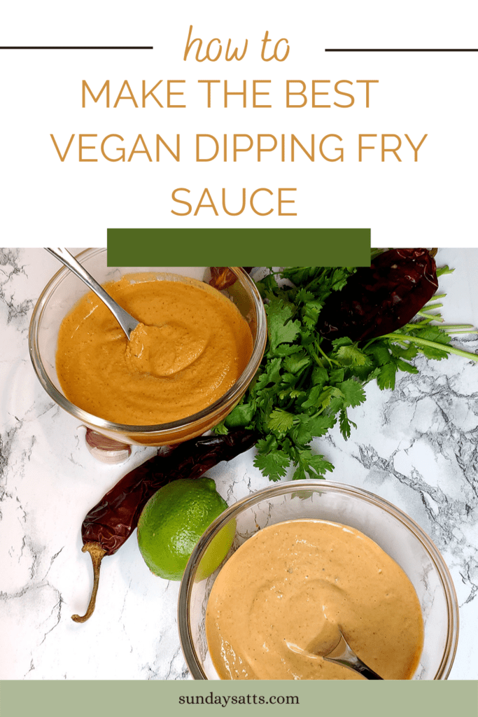 This is an image, from a different angle and with serving spoons, of two bowls with the vegan chipotle aioli dipping sauce. One made with cashews and the other with plant-based mayonnaise. The bowls are staged with dried chipotle peppers, cilantro, garlic, and limes.