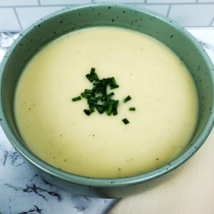 This is an image of the potato leek soup garnished with fresh chives.