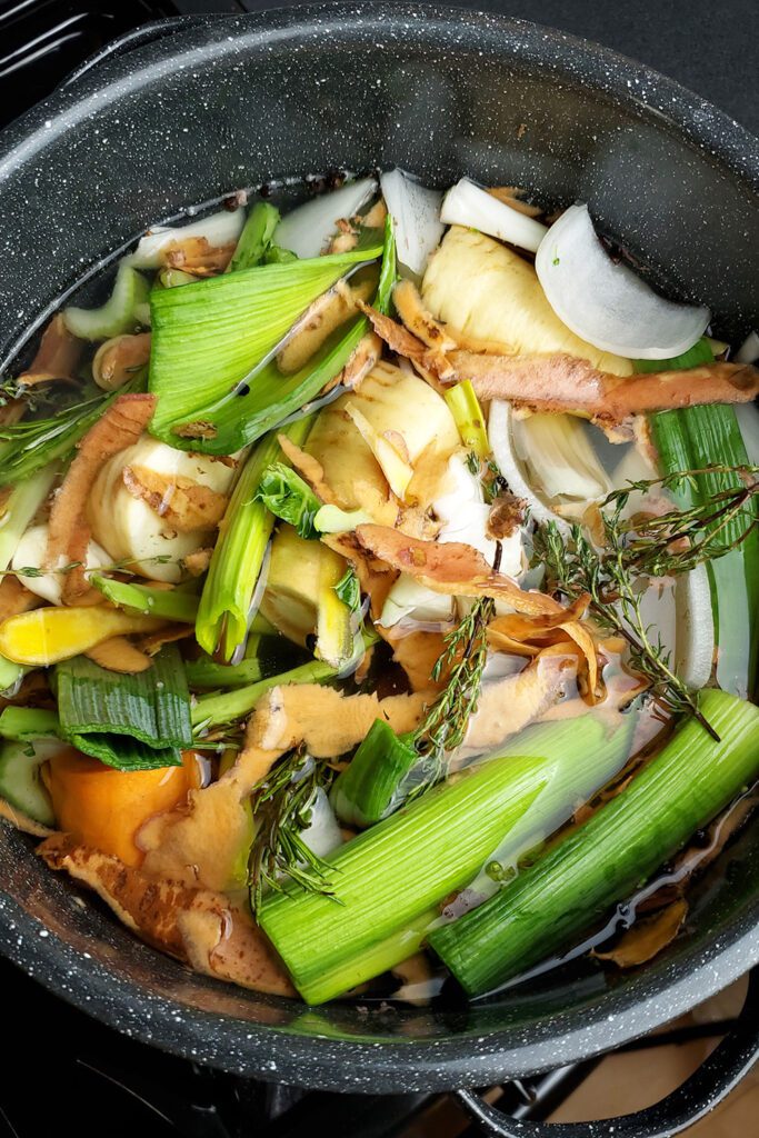 This is an image of a stock pot with vegetable scraps to make a tasty vegetable broth.