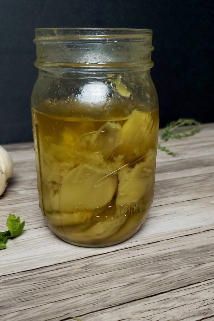 This is an image of Sundays at T's garlic confit in a glass mason jar ready for storage.