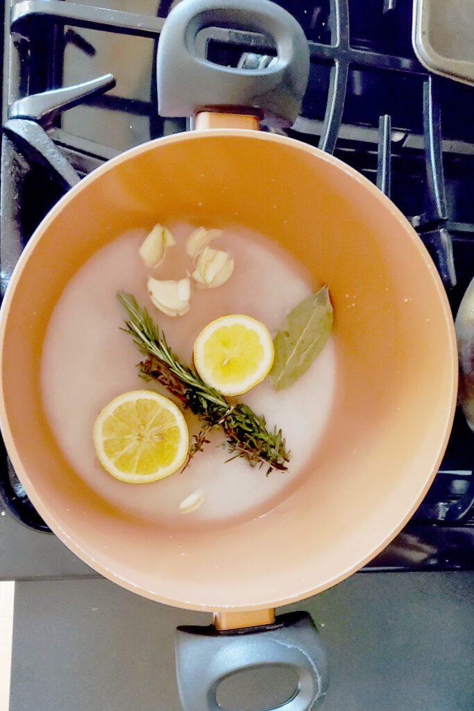 Making the brine recipe by first dissolving the salt and sugar with your herbs and spices in boiling water.