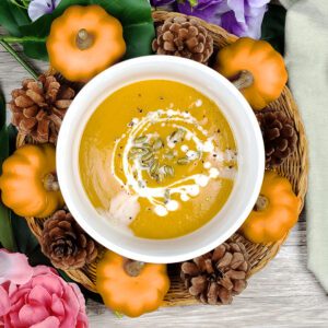 This is an image of Sundays at T's butternut squash bisque garnished with coconut cream and pepitas.
