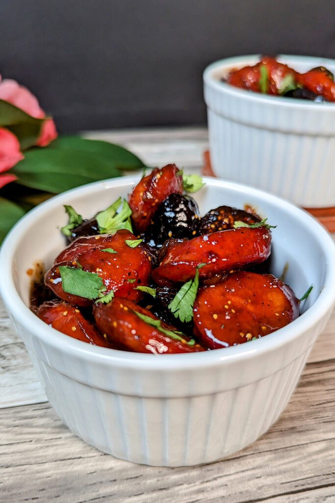 This is an image of the chorizo and fig tapas served in a ramekin and garnished with fresh cilantro.