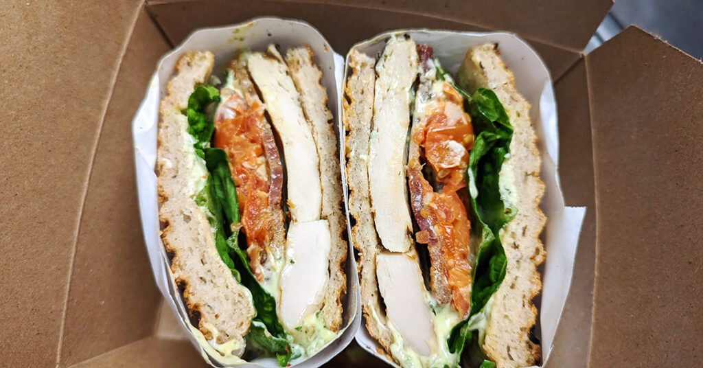This is an image of Café Avalaun's gluten-free grilled chicken club sandwich.