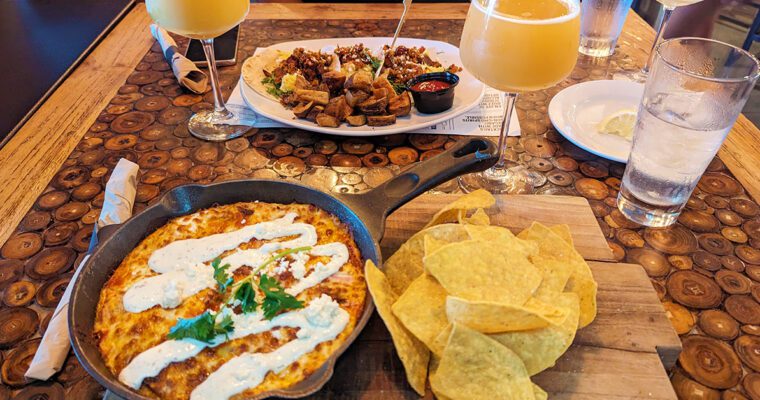 This is an image of the huevos rancheros skillet with the breakfast tacos in the background from TownHall in Cleveland, Ohio.