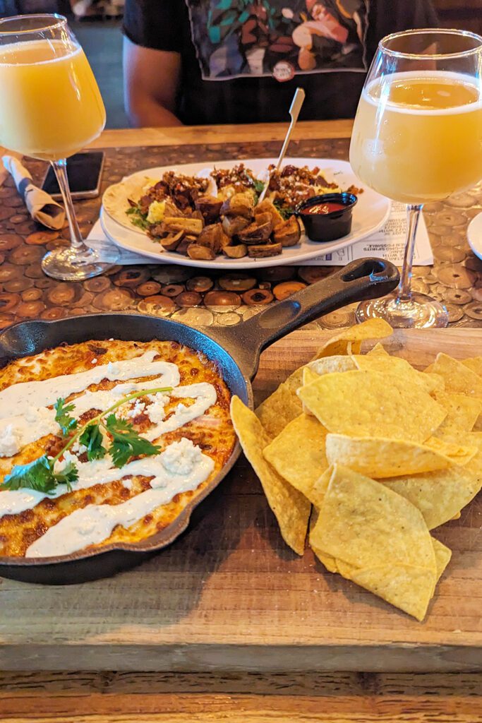This is an image of the huevos rancheros skillet with the breakfast tacos in the background from TownHall in Cleveland, Ohio.