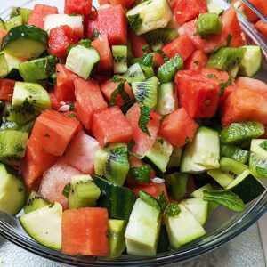 This is an image of the watermelon, cucumber, and kiwi salad garnished with fresh mint from Sundays at T's.