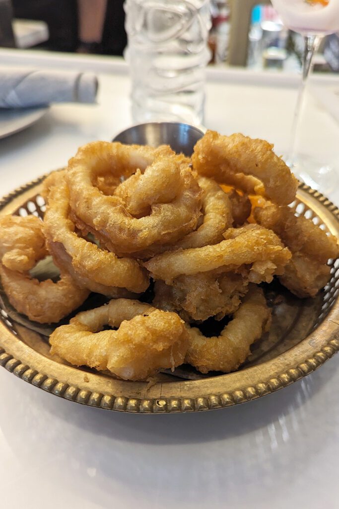 This is an image of the gluten-free fried calamari from Sisters Thai Alexandria. Safely enjoy gluten-free items at Sisters Thai because they use a separate cook station.