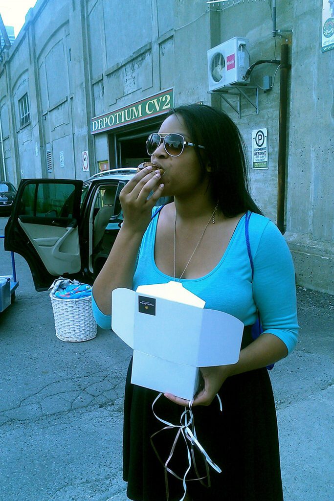 This is an image of T eating a delicious chocolate eclair on the streets of Montreal, Quebec, Canada.