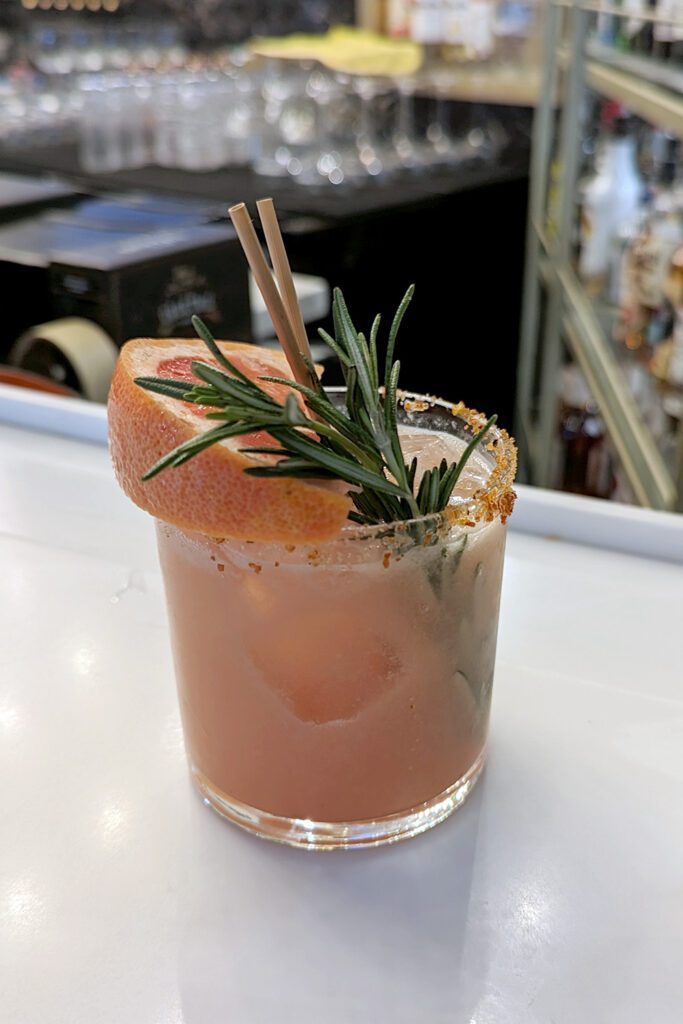 This is an image of the The Reminder, a craft cocktail from Sisters Thai Alexandria. Enjoy this tequila-based cocktail with the amazing aroma of fresh rosemary.