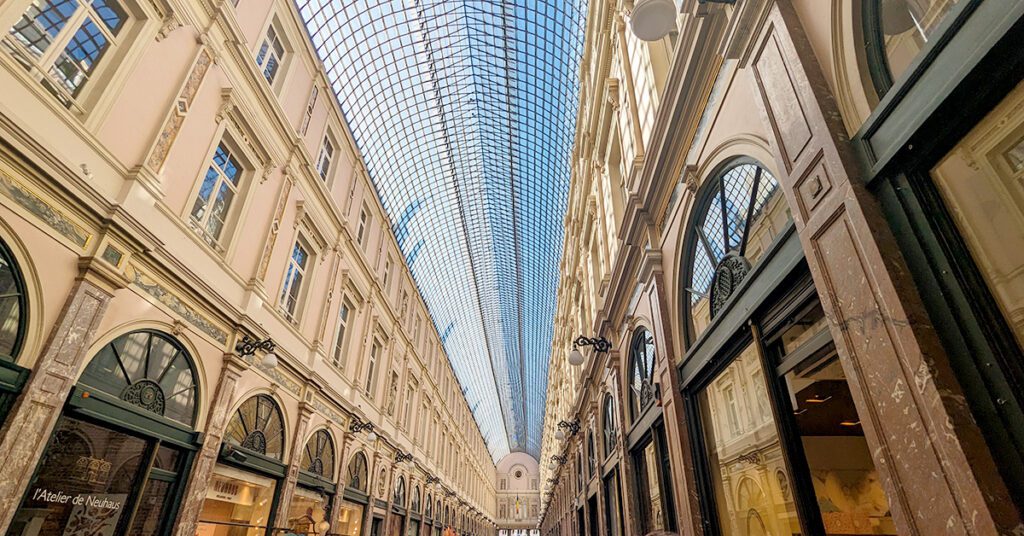 This is an image of Galerie du Roi, a popular covered market in Brussels, Belgium. At the market you can find famous chocolatiers, delicious foods, and a few trinkets. You have to put Galerie du Roi in your Brussels itinerary for your next visit.