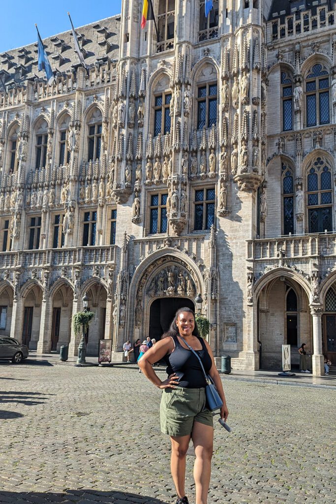 This is an image of T at Grand Place in Brussels, Belgium before the walking tour. A free walking tour is a great way to see many sights that may be on your Brussels itinerary.